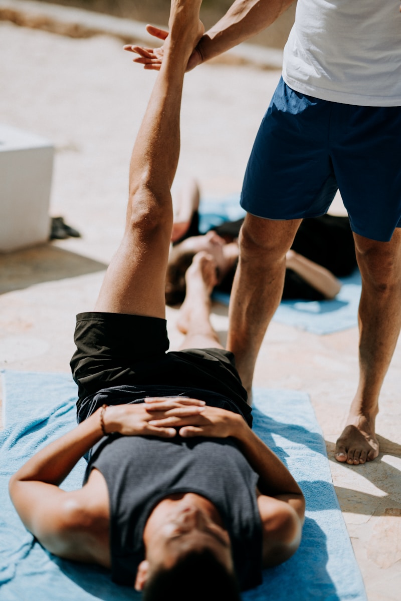 Photo by Annie Spratt man lying on floor near man standing holding his leg